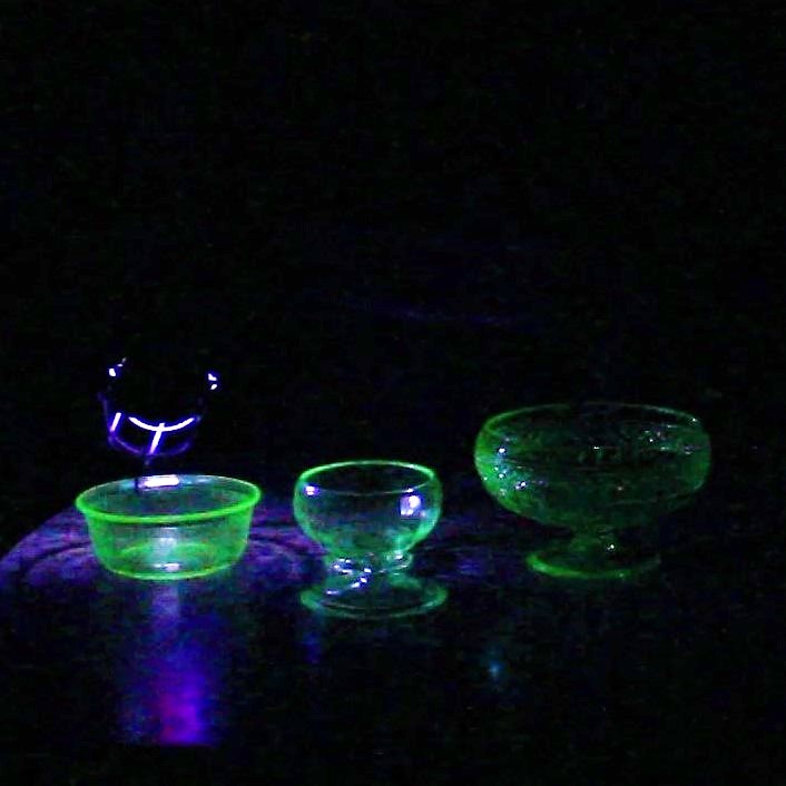 Uranium Glass Fluorescing Under UV Light